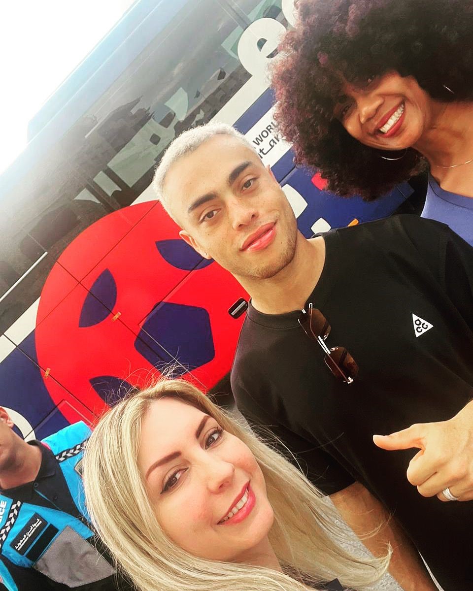 Team USA Defender Sergiño Dest (center) visits the USA Pavilion