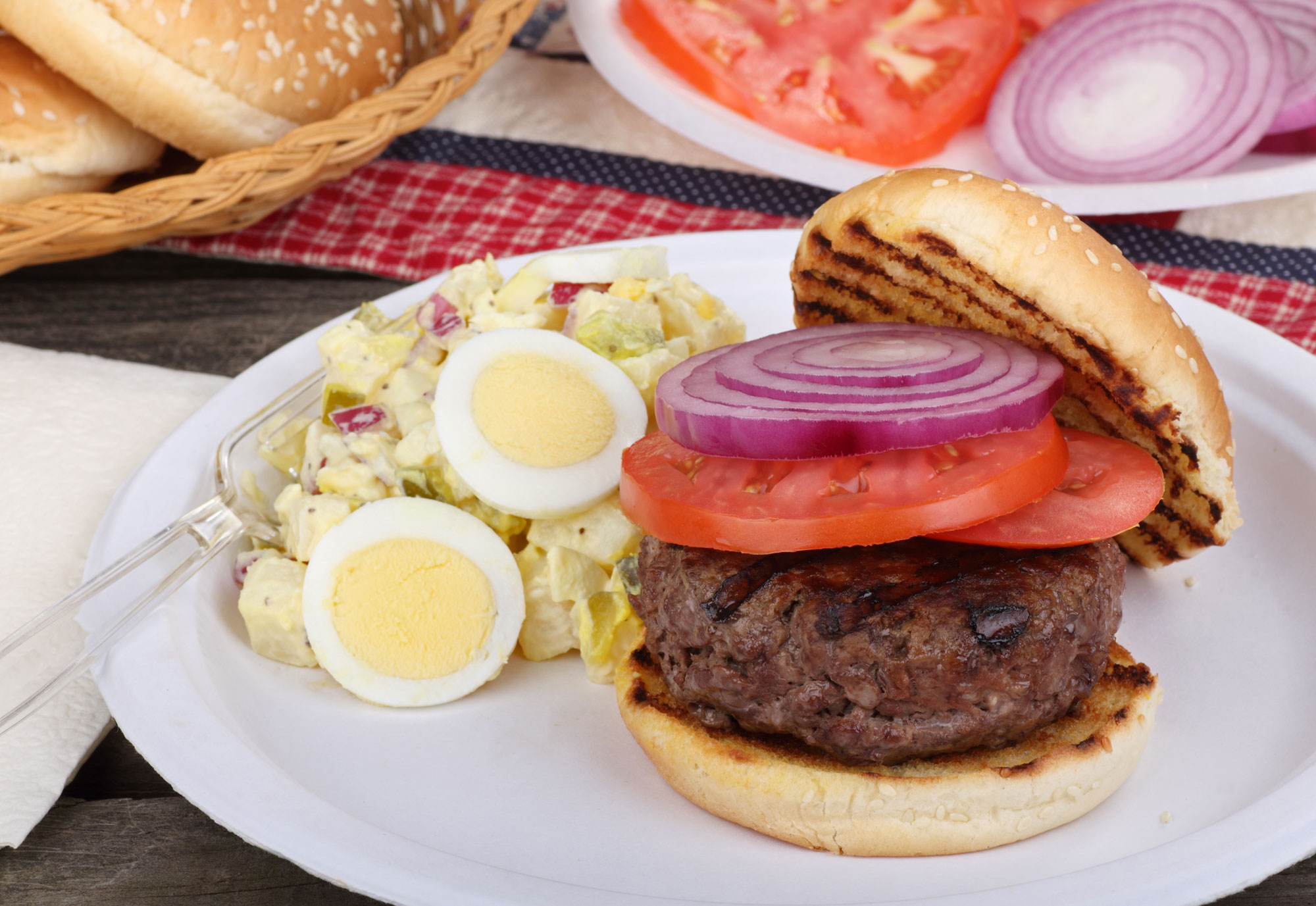 A plate with a burger and egg salad