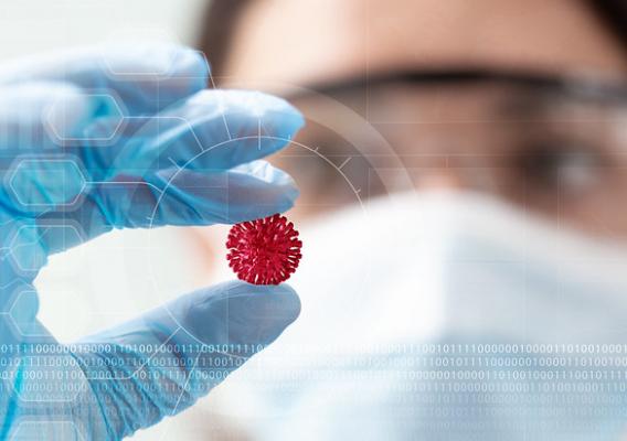 A woman scientist holding a coronavirus in a research lab