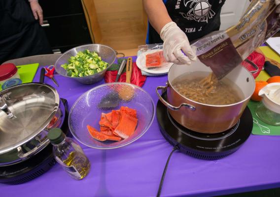 Closeup of person with plastic gloves preparing food