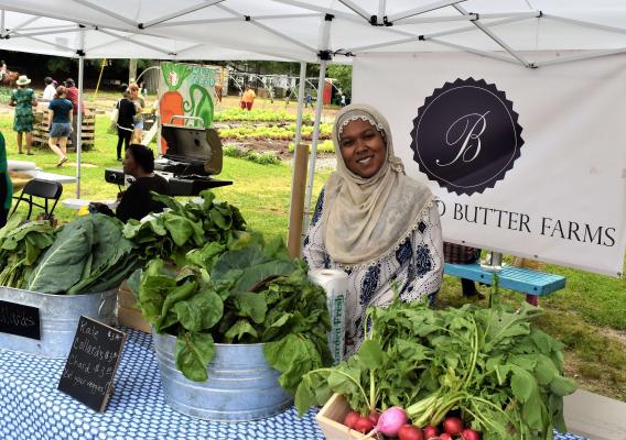 A woman farmer at a farmers market