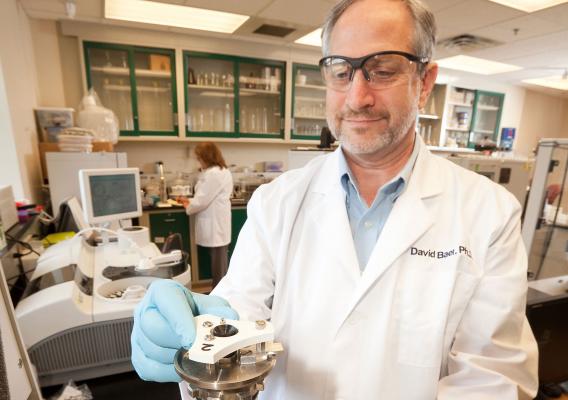 A scientist analyzes diet study samples in a laboratory