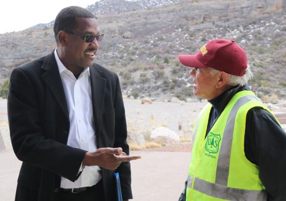 Under Secretary Homer Wilkes talking with a Forest Service volunteer