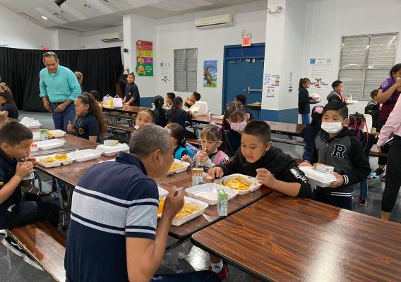 WRO Regional Administrator Jesus Mendoza, Jr., listens as a student at Ordot/Chalan Pago Elementary talks about his favorite breakfast food