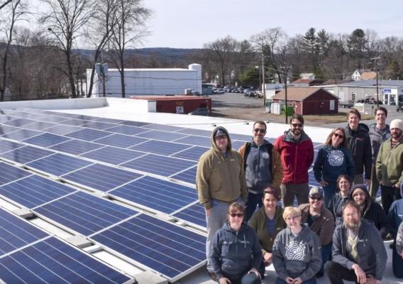 Real Pickles Co-op Members stand on top of the building