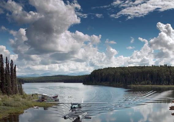 A float plane landing on an Alaskan river