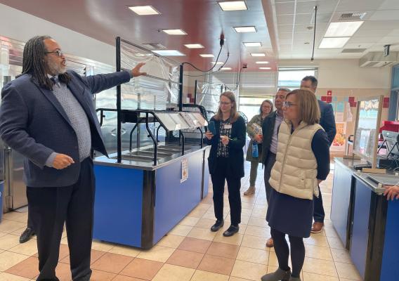 Administrator Cindy Long touring school cafeteria at Chula Vista Middle School with school nutrition staff