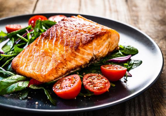 A plate with salmon and vegetables