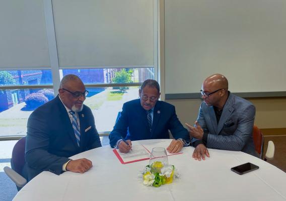 Acting Assistant Secretary Malcom Shorter, Congressman Sanford D. Bishop, Jr. and Executive Director Michael Hill sitting at table discussing the importance of collaboration to aid small businesses