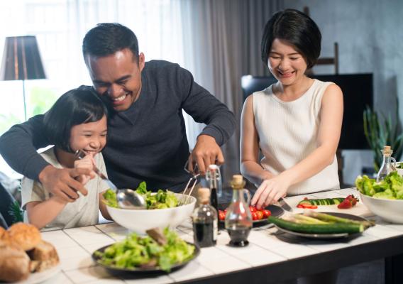 Family eating food at a dinner table